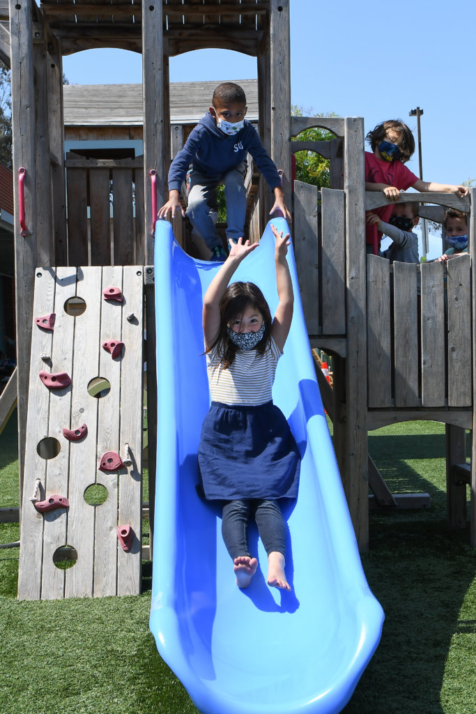 Children going down a slide at WNS Early Childhood Center in Playa Vista, CA